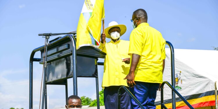 President Yoweri Museveni handing over the NRM flag to NRM Flag Bearer of Oyam North constituency Engola Okello Samuel the son of the late of Rtd. Col. Charles Ongola Macodwogo at Otwal Primary School Otwal Sub-County, Oyam District on 4th July 2023. Photo by PPU/Tony Rujuta.