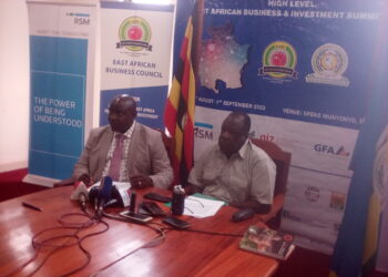 EABC CEO John Kaliisa (Left) is flanked by Minister of State for EAC James Ikuya during the Press Conference in Kampala on Tuesday