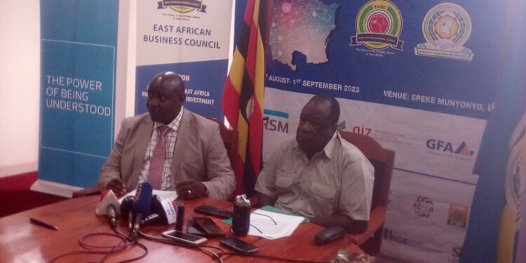 EABC CEO John Kaliisa (Left) is flanked by Minister of State for EAC James Ikuya during the Press Conference in Kampala on Tuesday