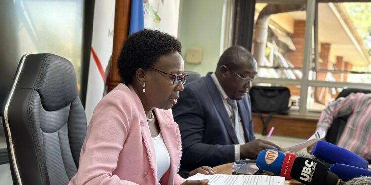 Minister Aceng addressing the media