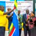 Prime Minister Robinah Nabbanja (Right) handing over EAC Flag to Rwandan Representative at the Conclusion of World Kiswahili Day in Kampala