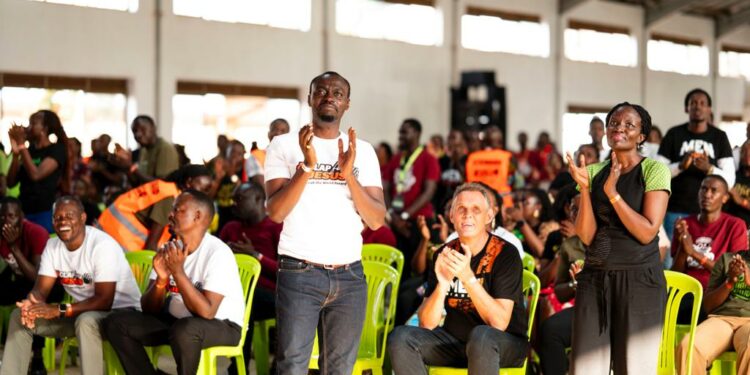 Apostle Grace Lubega leading his team to clap for Jesus