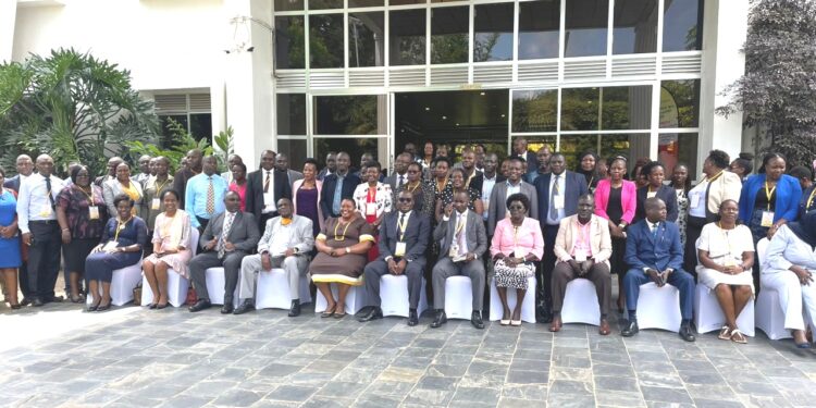 Minister Babalanda,  Hajji Yunus Kakande and Administrative Officers in a group photo.