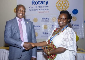 Makerere University Vice Chancellor Prof Barnabas Nawangwe pose for a photo with Associate Professor Consolata Kabonesa after being installed as the president of Rotary Club of Makerere Rainbow over the weekend