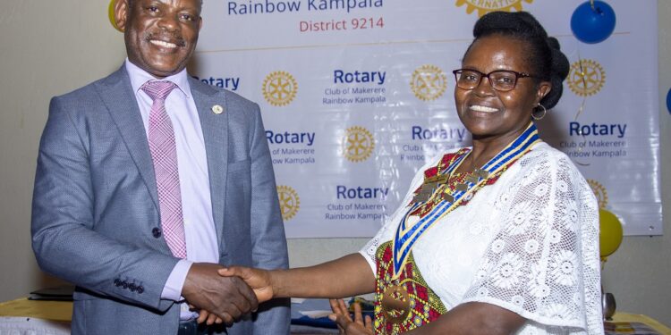 Makerere University Vice Chancellor Prof Barnabas Nawangwe pose for a photo with Associate Professor Consolata Kabonesa after being installed as the president of Rotary Club of Makerere Rainbow over the weekend