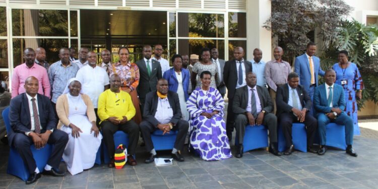 Hajji Yunus Kakande, Hon Amelia Kyambadde in a group photo with RDCs/RCCs/Deputies, RISOs and DISOs in a group photo