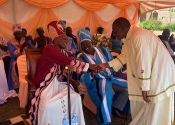 Catechist Jasper Onume greets Paramount Chief Eng Dr Michael Moses Odongo-Okune during the installation ceremony of Santo Angodo as the clan chief(awitong)of Bakocol in Lira City.