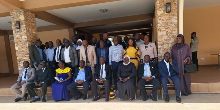 Hajji Kakande, Mr. Kisuyi, Hajjat Malole, officials from the RDC secretariat in a group photo with RDCs/RCCs,  RISO and DISOs