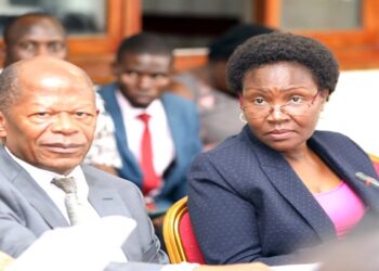 Minister Muyingo (L) and his permanent secretary, Ketty Lamaro, appearing before the education committee