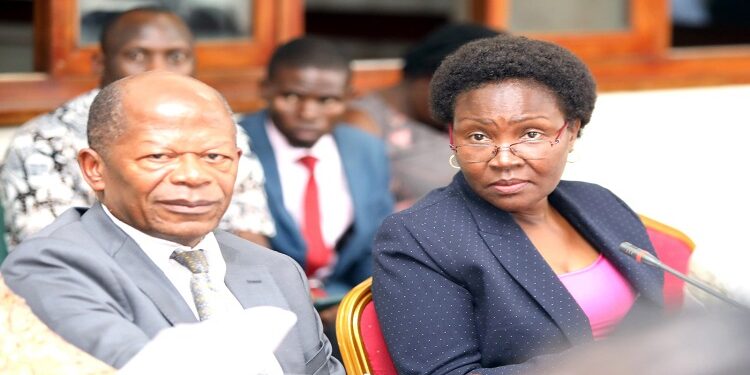 Minister Muyingo (L) and his permanent secretary, Ketty Lamaro, appearing before the education committee