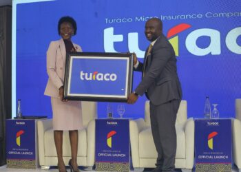 Hon Evelyn Anite (State Minister for Investment & Privatization) holds a plaque with Turaco Insurance GM Hamza Mutebi after Turaco officially became an insurance underwriter in Uganda.