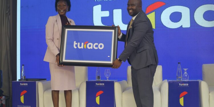 Hon Evelyn Anite (State Minister for Investment & Privatization) holds a plaque with Turaco Insurance GM Hamza Mutebi after Turaco officially became an insurance underwriter in Uganda.
