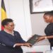 IGG Beti Kamya (L) hands over the report to Commissioner Afoyochan