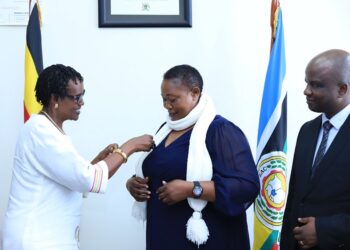 Ms. Winnie Byanyima giving the medal to Hon. Babalanda