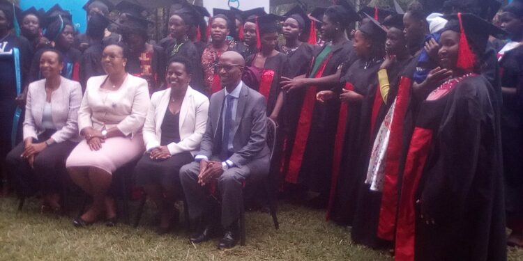 Minister Sarah Mateke (2nd Left) poses for a group photo with the graduand girls and their mentors at Fairway Hotel on Tuesday