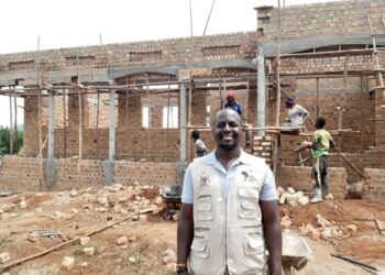 Mr Musaazi standing infront of the new home