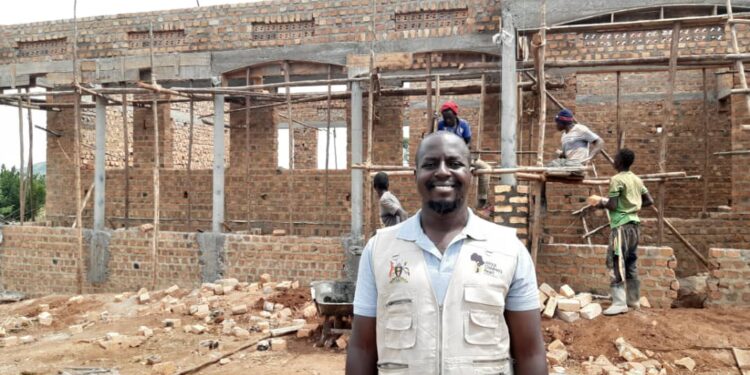 Mr Musaazi standing infront of the new home