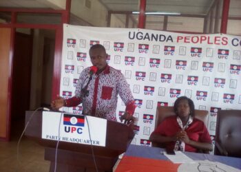 Muzeyi Faizo, UPC Head of Media and Communications is flanked by the Party Spokesperson, Arach Oyat Sharon during the Press briefing at UPC Headquaters on Uganda House in Kampala on Wednesday