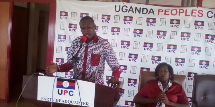 Muzeyi Faizo, UPC Head of Media and Communications is flanked by the Party Spokesperson, Arach Oyat Sharon during the Press briefing at UPC Headquaters on Uganda House in Kampala on Wednesday