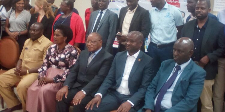 Prof. Ezra Suruma (3rd Right) is flanked by Parliamentary Forum for Social Protection members during the dialogue on Wednesday at Kampala Hotel Africana