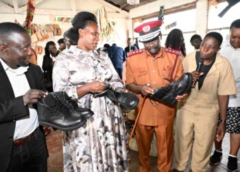 A student explaining to Ms. Barekye, Dr Byabashaija and Dr.katana how they managed to come up with quality leather shoes