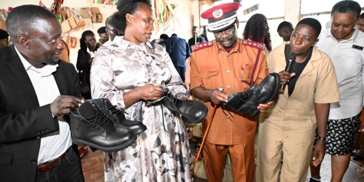 A student explaining to Ms. Barekye, Dr Byabashaija and Dr.katana how they managed to come up with quality leather shoes