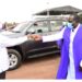President Museveni handing over car keys to Bishop Moses  Odongo