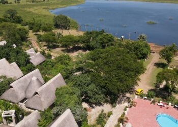 An aerial view of Arra Fishing Lodge stretching to the shoreline of the Albert Nile