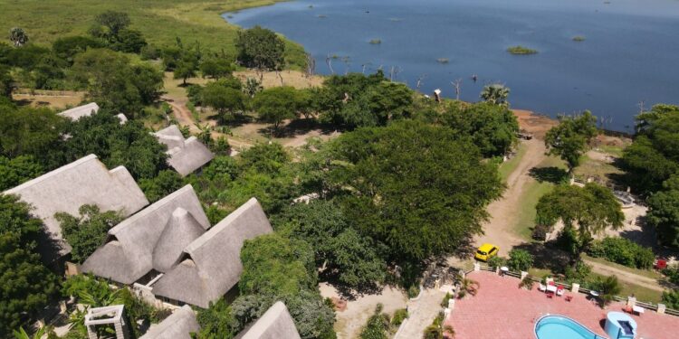 An aerial view of Arra Fishing Lodge stretching to the shoreline of the Albert Nile