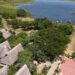 An aerial view of Arra Fishing Lodge stretching to the shoreline of the Albert Nile
