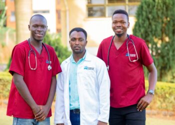 Teamwork Homecare's Founder and CEO Julius Habumugisha in the middle with some of his staff outside their offices