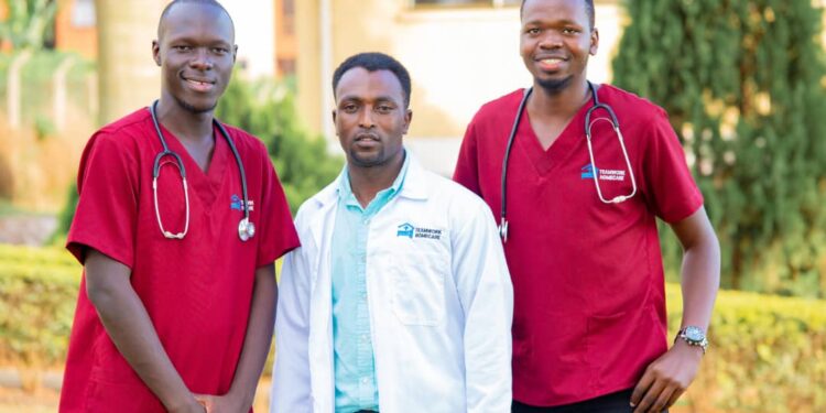 Teamwork Homecare's Founder and CEO Julius Habumugisha in the middle with some of his staff outside their offices