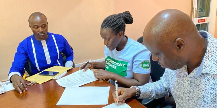 From left: Gad Kwizera (Assist. Agriculture Lecturer, Lira University), Nancy Mugimba (National Coordinator, ESAFF Uganda), and Hakim Baliraine (National Chairperson, ESAFF Uganda) sign an MoU to spearhead agroecology study programs at Lira University.