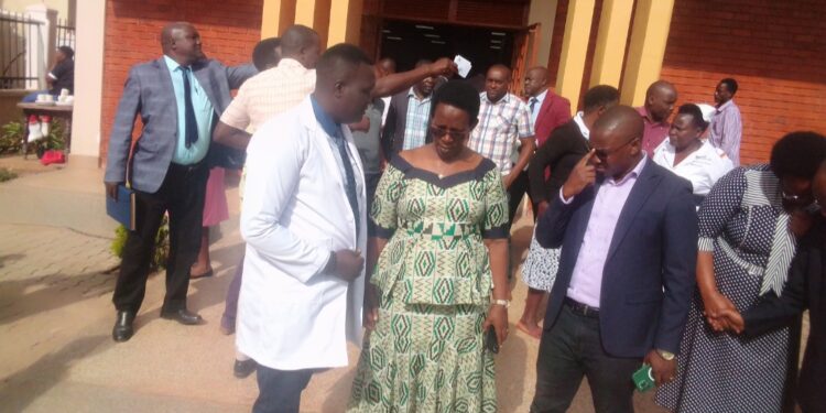 Dr Oledo speaking to Dr Diana Atwiine after a short meeting with health workers from Kigezi subregion at Kabale Regional Referral Hospital.