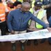 Tayebwa (C) being shown the design and layout of the Mpigi - Busega Expressway