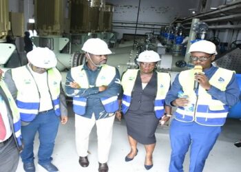 Tayebwa (C) inside the pumping room at the facility in Katosi