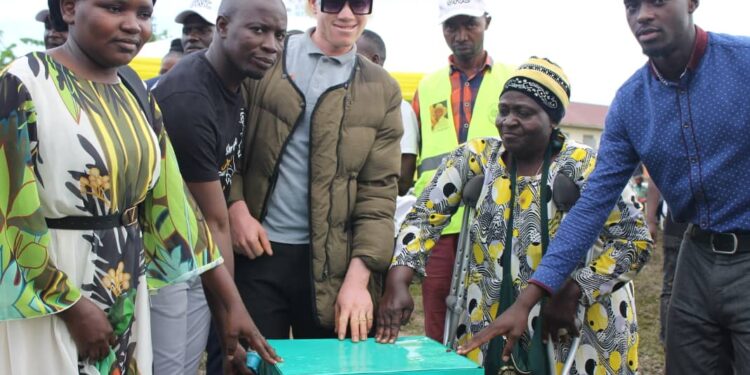 Moses Kintu the Assitant ONC communications Manager while handing over wealth Creation items to the youth in Mpigi District