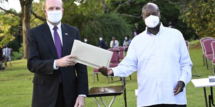President Yoweri Kaguta Museveni hands over a letter to the United States of America Ambassador to Uganda William Popp after a meeting at the State House Entebbe on the 4th December 2023. Photo by PPU/Tony Rujuta.