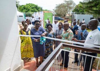 The State Minister For Northern Uganda, Hon. Grace Kwiyucwiny officially opens the UDB Northern Uganda Regional Office in Gulu City among other Government and UDB officials.