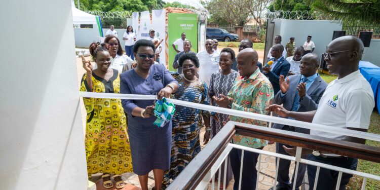 The State Minister For Northern Uganda, Hon. Grace Kwiyucwiny officially opens the UDB Northern Uganda Regional Office in Gulu City among other Government and UDB officials.