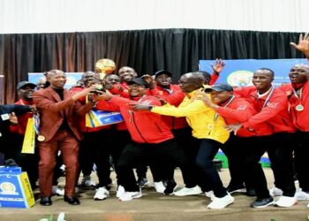 The football team lift their trophy after going unbeaten