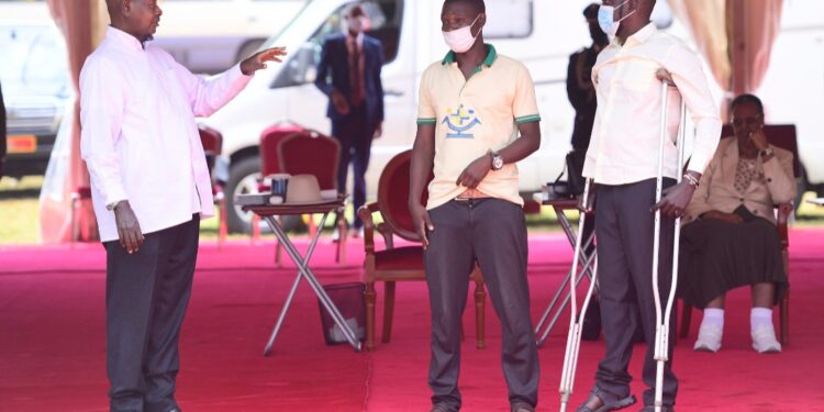 President Museveni with Moses Ssimbwa (extreme right) during the 38th NRM victory day anniversary celebrations in Jinja