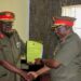 Brig-Gen-Godwin-Karugaba-L-receives-a-report-from-Brig-Gen-Charles-Bakahumara