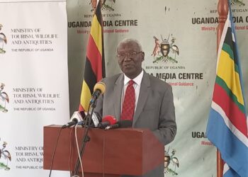 Hon. Tom Butiime addressing Journalists at the Uganda Media Centre on Tuesday