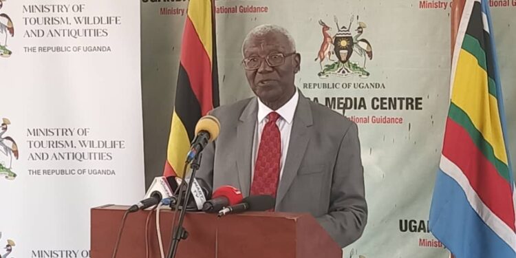 Hon. Tom Butiime addressing Journalists at the Uganda Media Centre on Tuesday