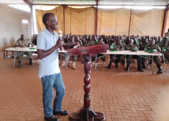 Dr Charles Michael Karimbaka making a presentation to the UPDF officers.