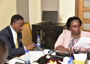 Finance Committee Chairperson, Hon. Amos Kankunda (left) and the Director for Information at NPC, Stella Kigozi, during the committee meeting on Monday 26 February 2024