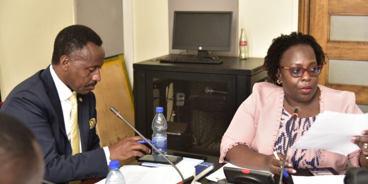 Finance Committee Chairperson, Hon. Amos Kankunda (left) and the Director for Information at NPC, Stella Kigozi, during the committee meeting on Monday 26 February 2024