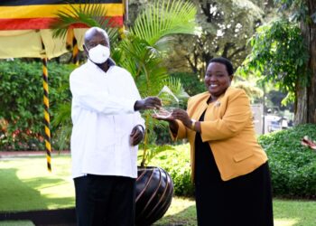 President Museveni receiving the award from Rt Hon. Nabbanja