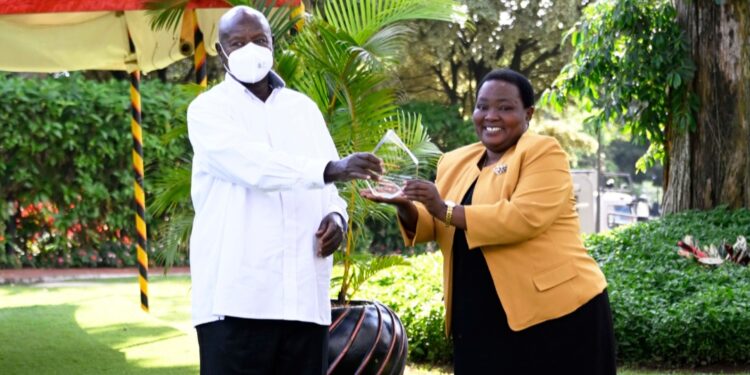 President Museveni receiving the award from Rt Hon. Nabbanja